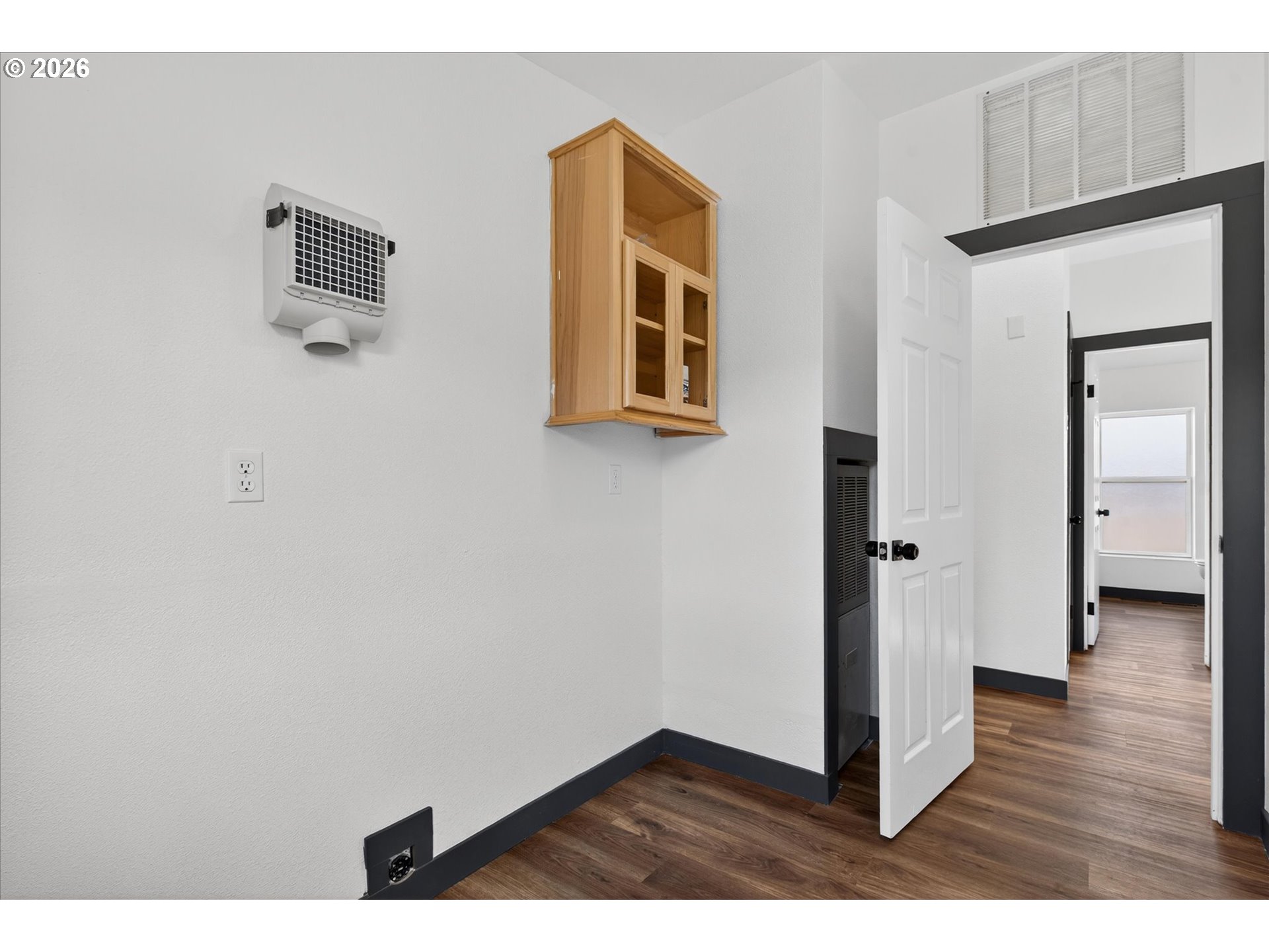 208 16th Street La Grande, OR 97850 - Photo 31 of 42 a view of an empty room with wooden floor and a window
