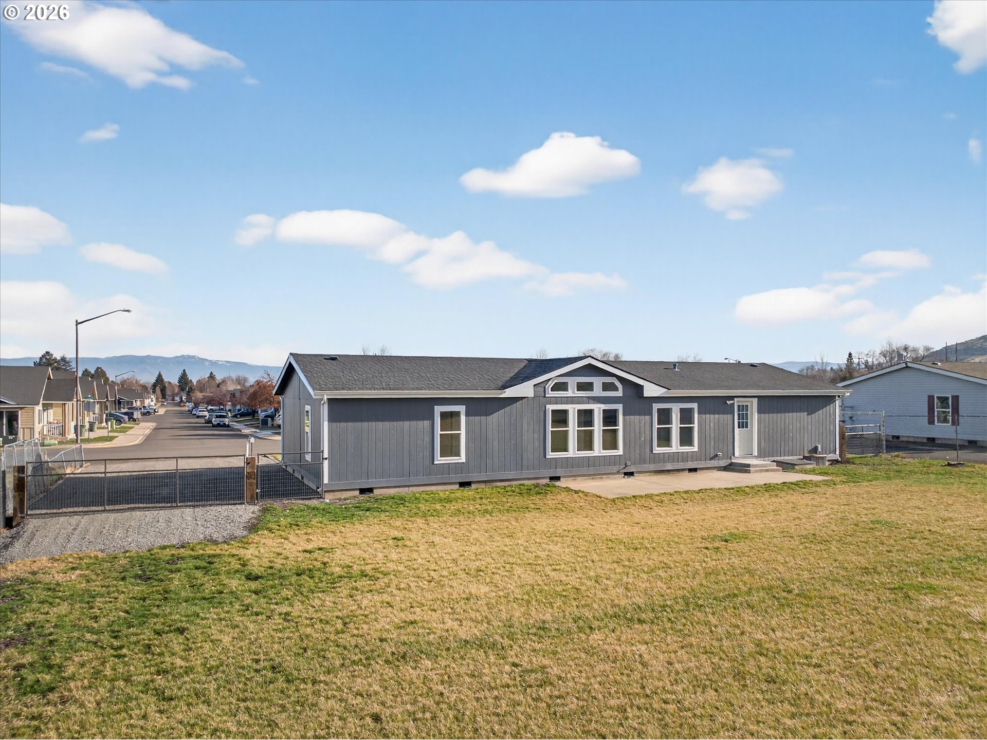 208 16th Street La Grande, OR 97850 - Photo 33 of 42 a view of a house with a big yard and large trees