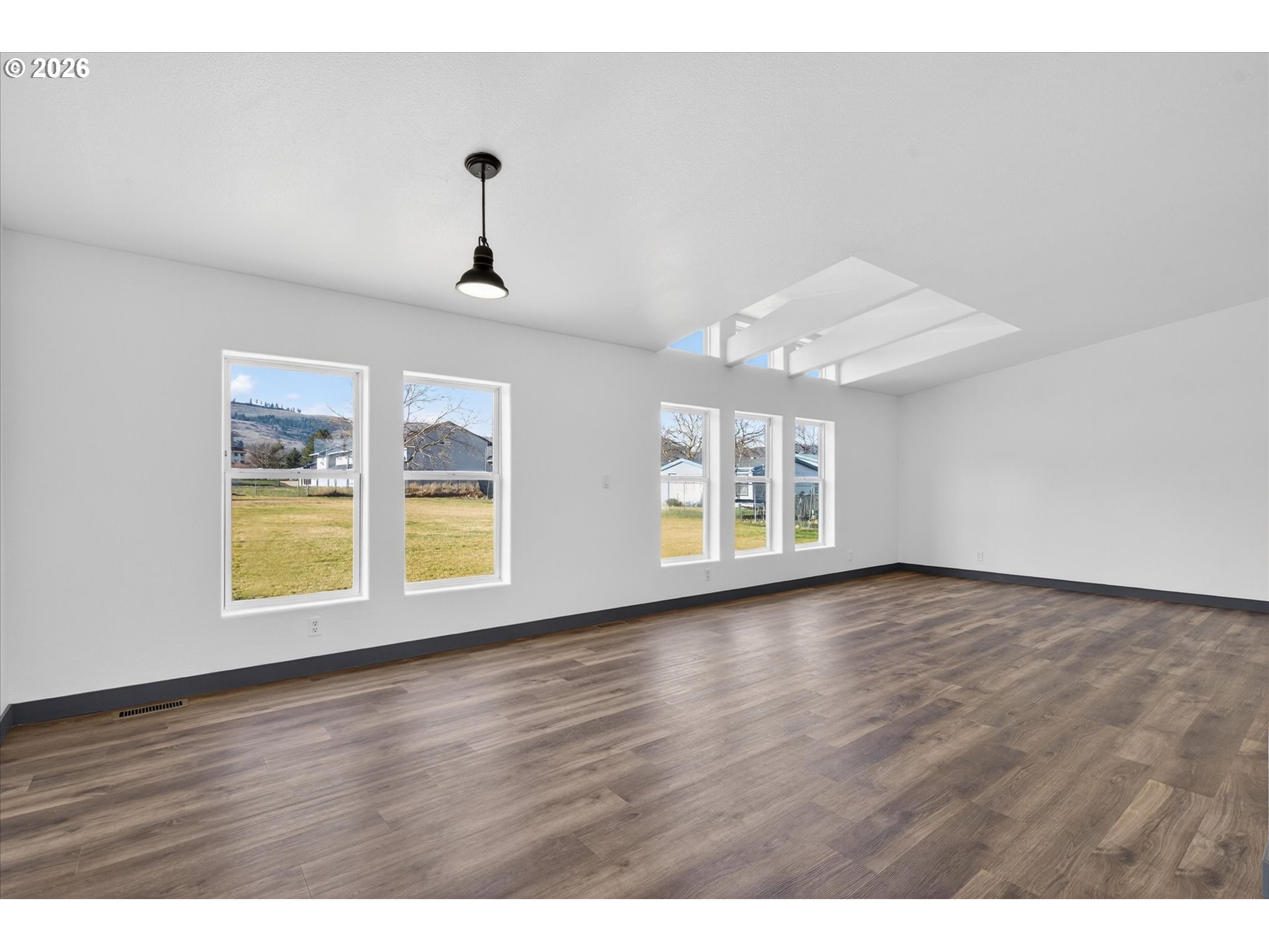 208 16th Street La Grande, OR 97850 - Photo 9 of 42 a view of an empty room with wooden floor and a window