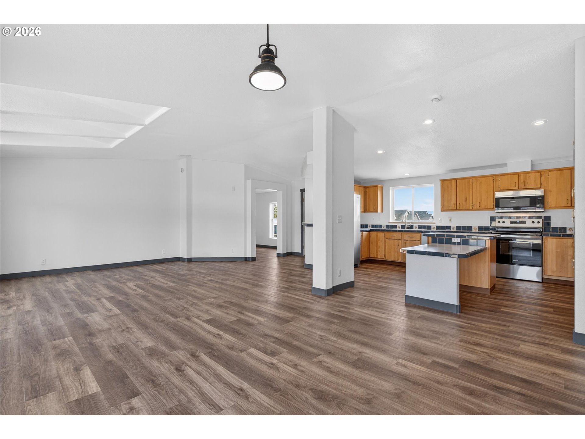 208 16th Street La Grande, OR 97850 - Photo 10 of 42 a view of kitchen with granite countertop stainless steel appliances and wooden floor