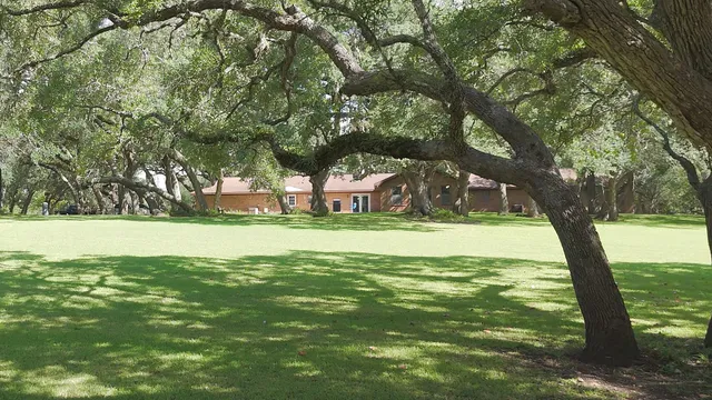 a view of living room filled with furniture and chandelier