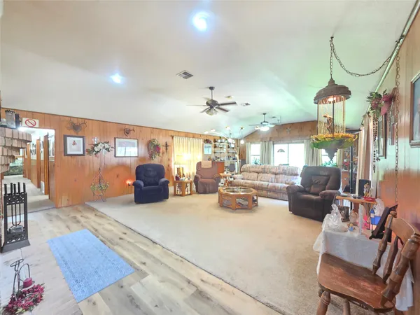 a view of living room filled with furniture and chandelier