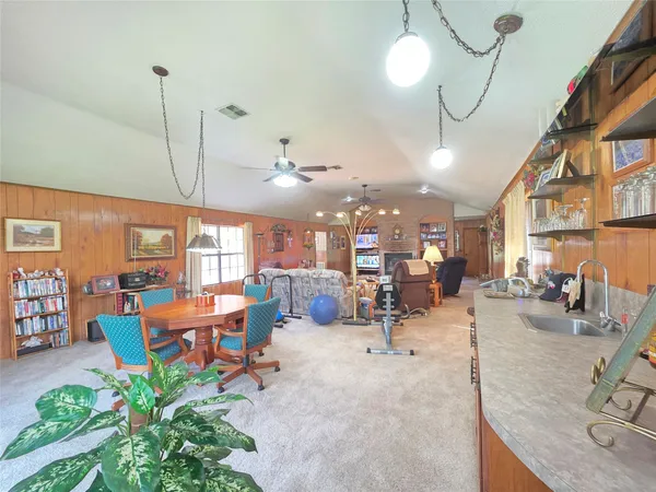 a living room with furniture a rug and a chandelier