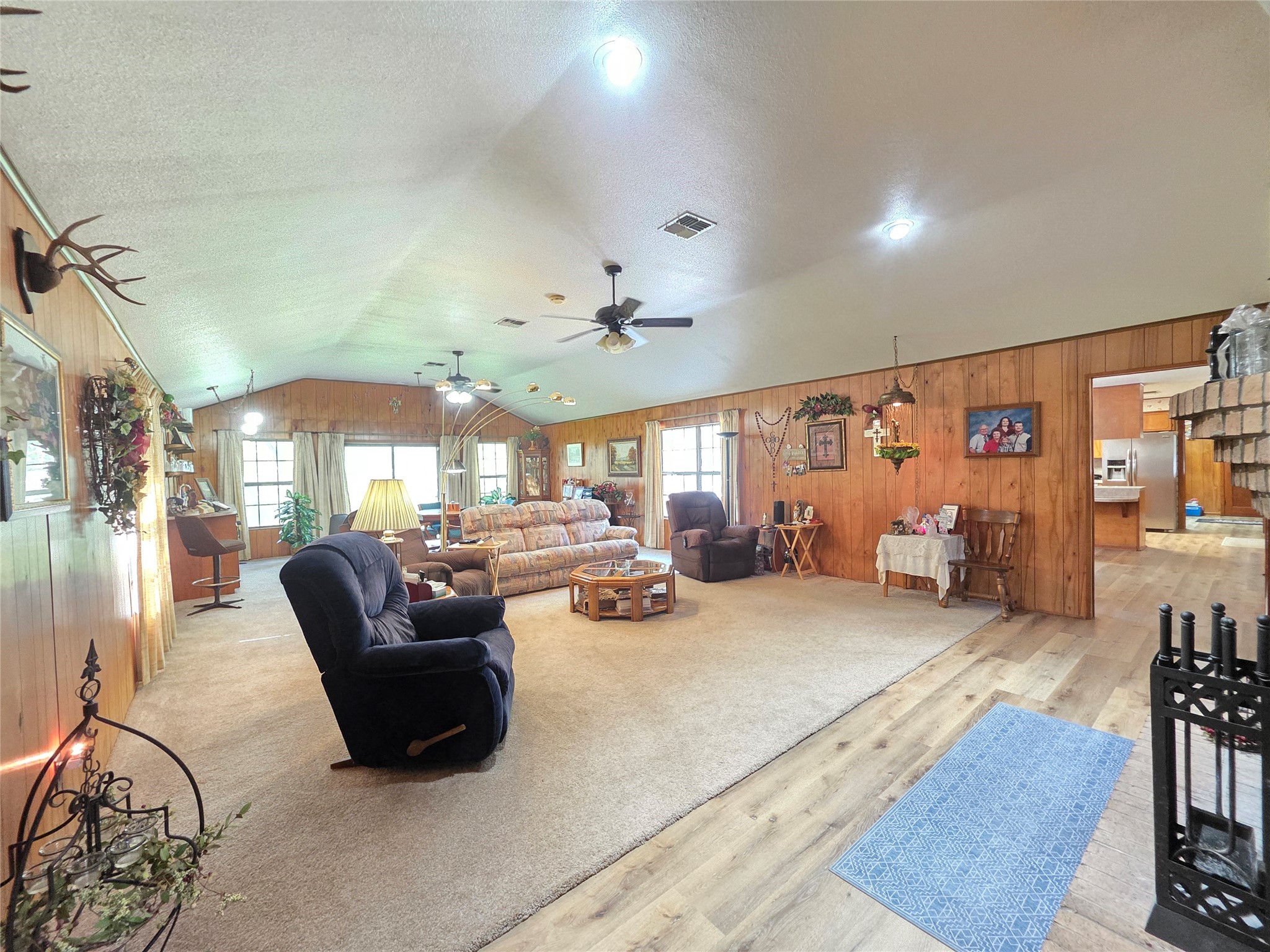 406 Wilson Creek Road Palacios, TX 77465 - Photo 22 of 49 a living room with furniture a rug and a chandelier