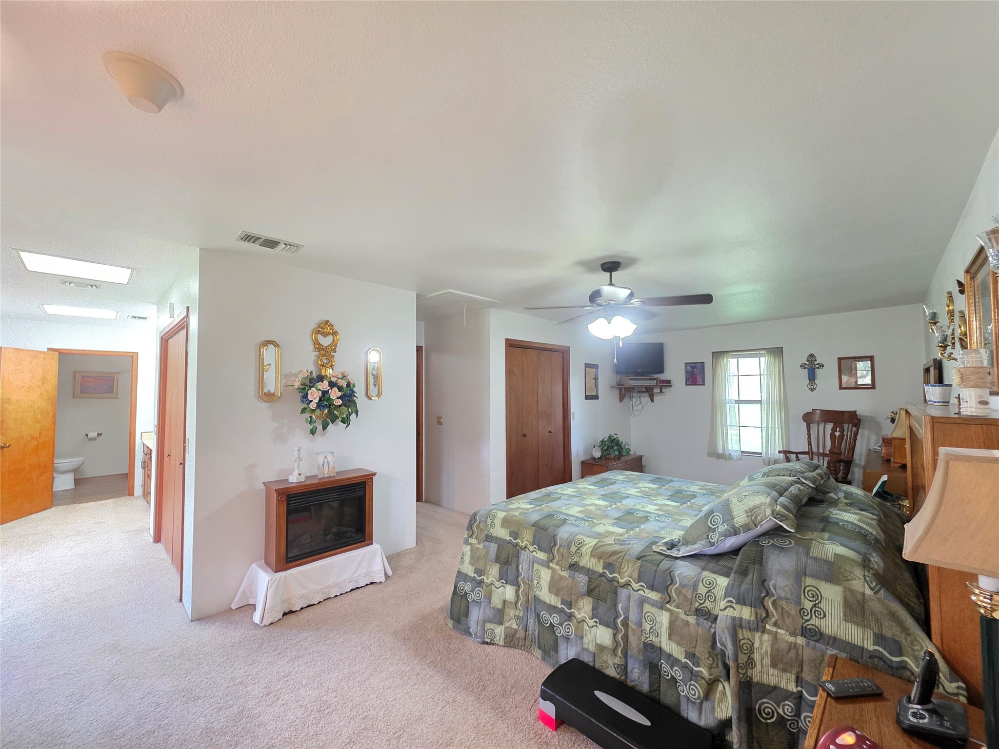 406 Wilson Creek Road Palacios, TX 77465 - Photo 25 of 49 a spacious bedroom with a bed and a fireplace