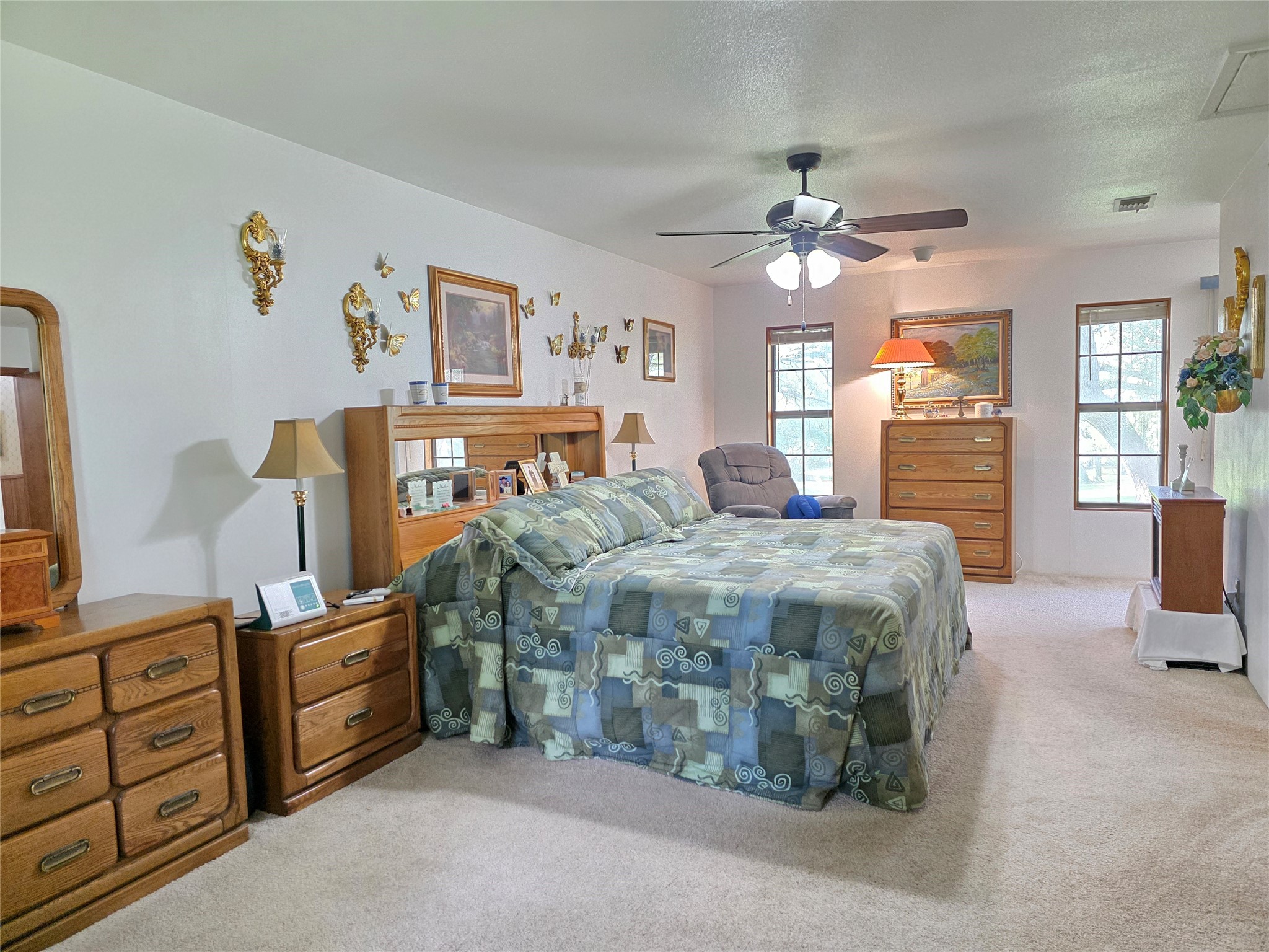 406 Wilson Creek Road Palacios, TX 77465 - Photo 26 of 49 a bedroom with a bed dresser and wooden floor
