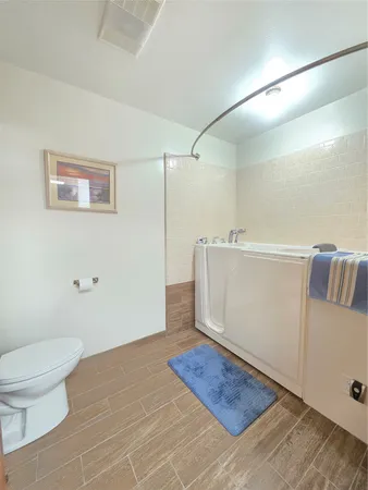a spacious bathroom with a granite countertop sink a mirror and a shower