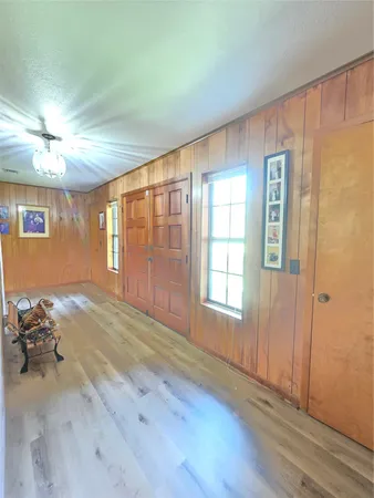 a view of a dining room with furniture a chandelier and wooden floor