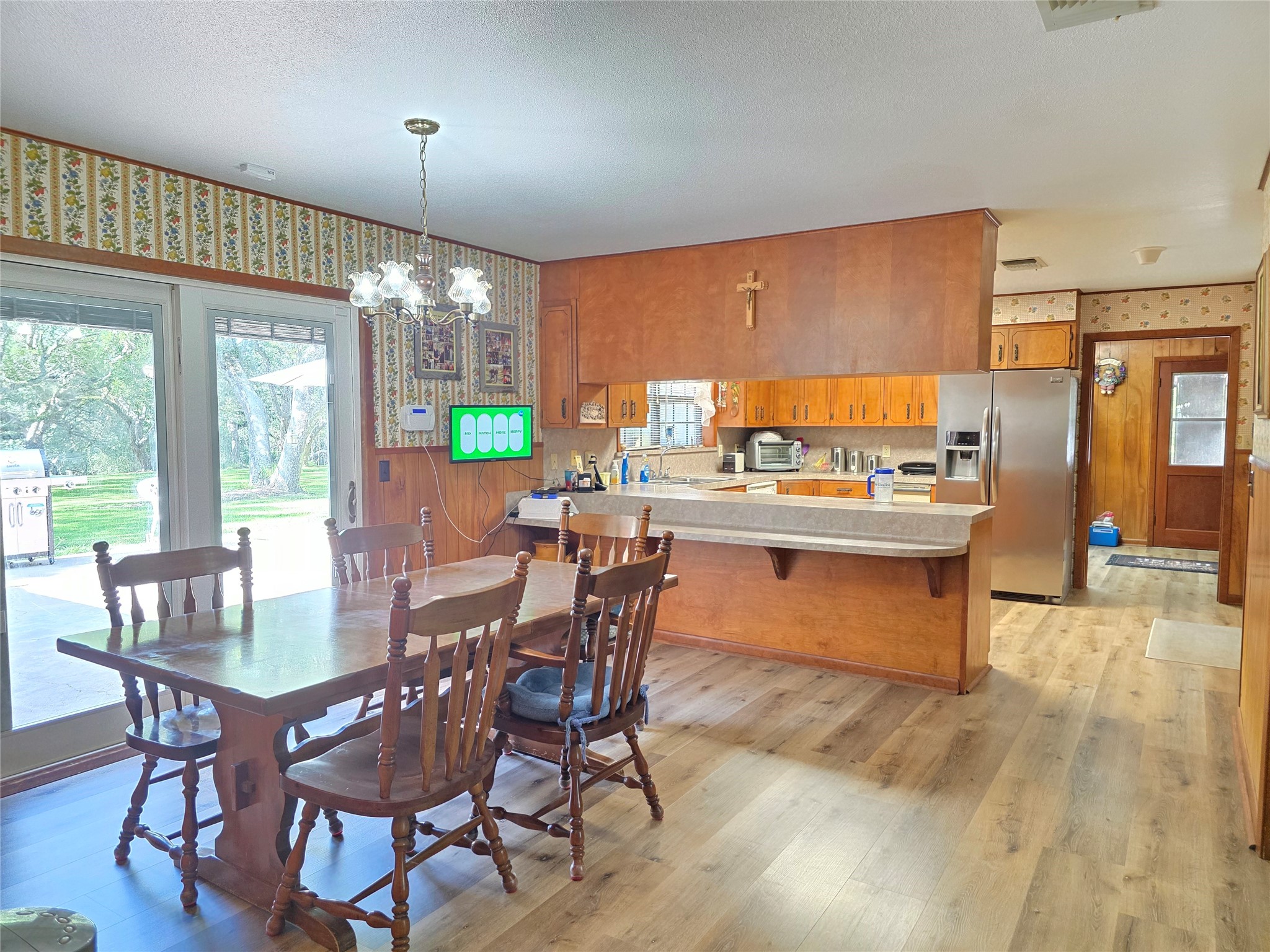 406 Wilson Creek Road Palacios, TX 77465 - Photo 33 of 49 a view of a dining room with furniture a chandelier and wooden floor