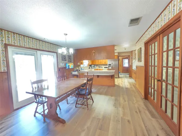 a kitchen with stainless steel appliances kitchen island granite countertop a sink stove and wooden cabinets