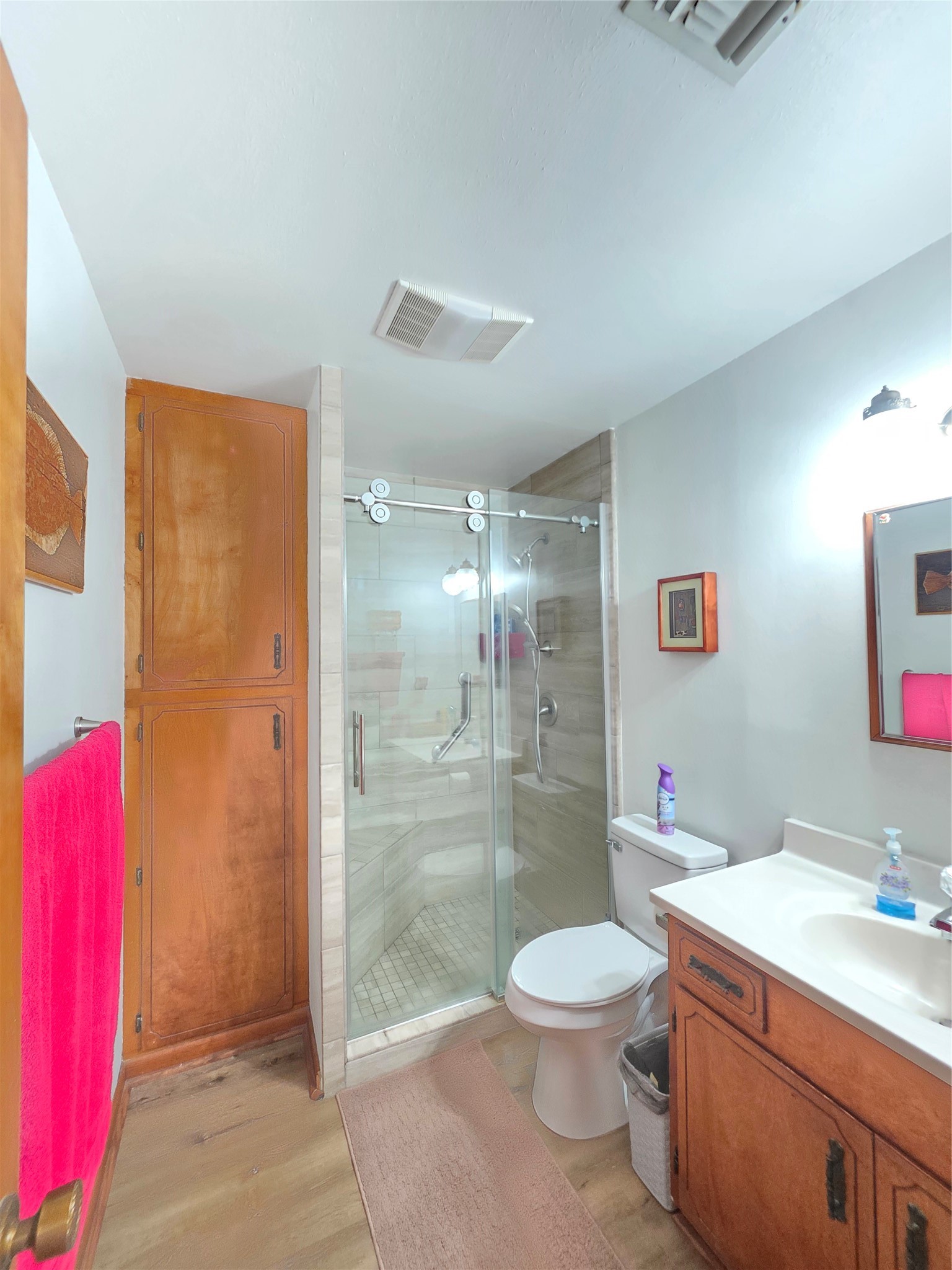 406 Wilson Creek Road Palacios, TX 77465 - Photo 42 of 49 a bathroom with a granite countertop sink a toilet a mirror and shower