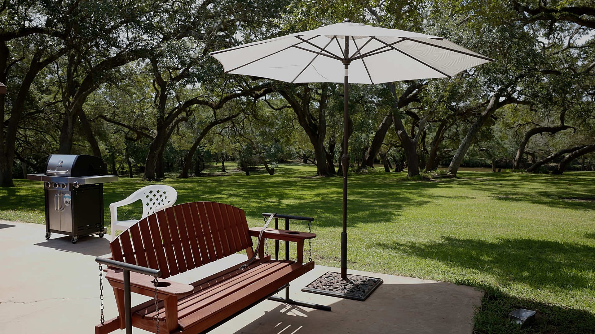 406 Wilson Creek Road Palacios, TX 77465 - Photo 7 of 49 a view of a table and chairs under an umbrella