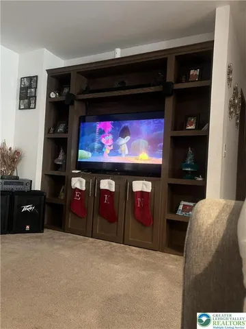 a living room with furniture and a ceiling fan