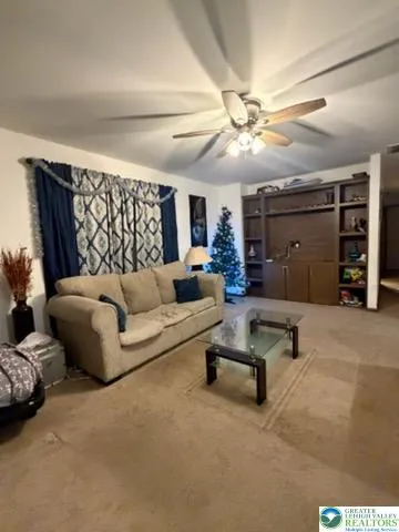 a living room with furniture and a chandelier