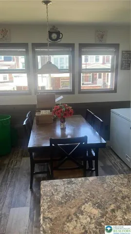 a room with kitchen island a counter top space and stainless steel appliances