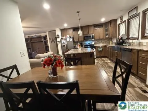 a kitchen with stainless steel appliances granite countertop a stove refrigerator and cabinets