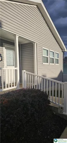 a view of a house with backyard and porch