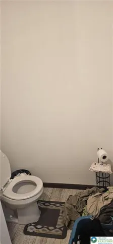 a view of a refrigerator in kitchen and an empty room