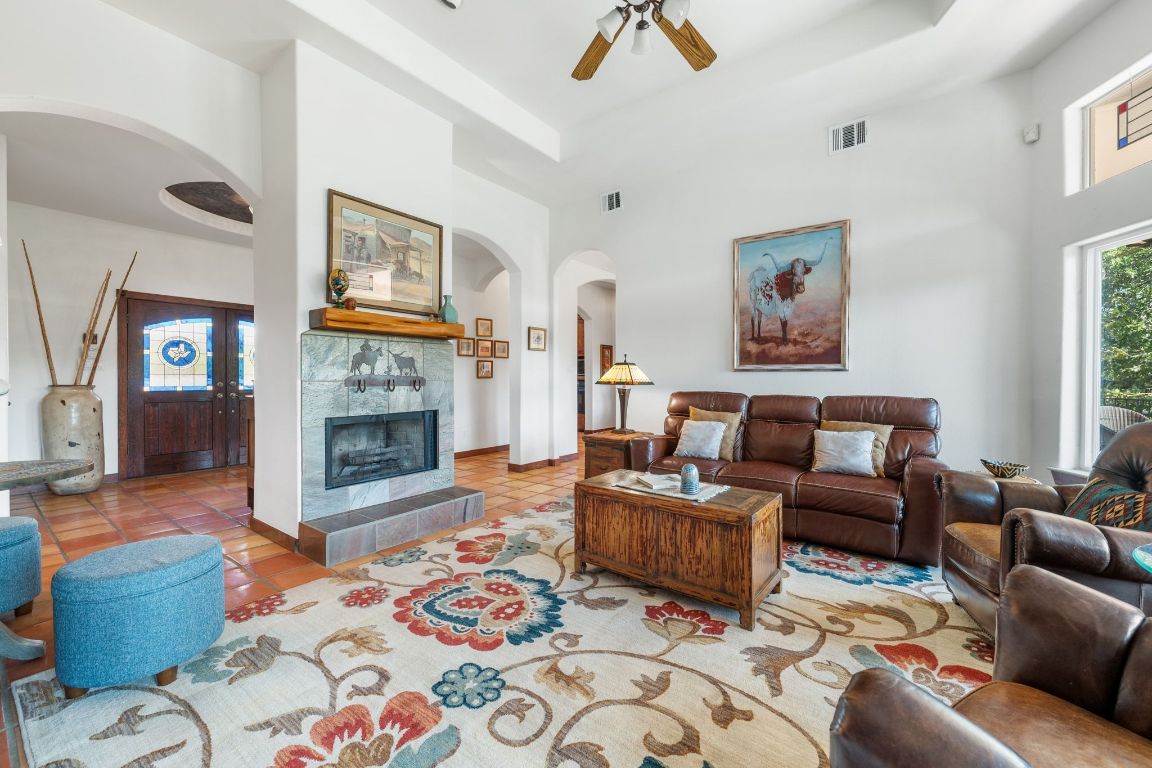 16312 Lake Loop Austin, TX 78734 - Photo 14 of 36 a living room with furniture and a fireplace