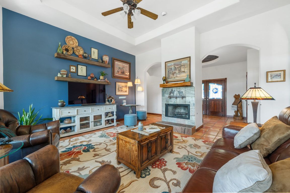 16312 Lake Loop Austin, TX 78734 - Photo 15 of 36 a living room with furniture flat screen tv and a fireplace