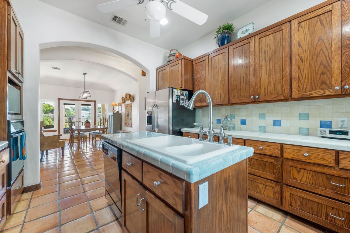 16312 Lake Loop Austin, TX 78734 - Photo 19 of 36 a kitchen that has a lot of cabinets in it and wooden floors