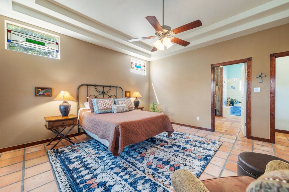 16312 Lake Loop Austin, TX 78734 - Photo 22 of 36 a bedroom with a bed and wooden floor