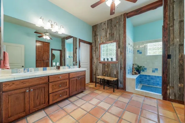 a spacious bathroom with a double vanity sink and a mirror