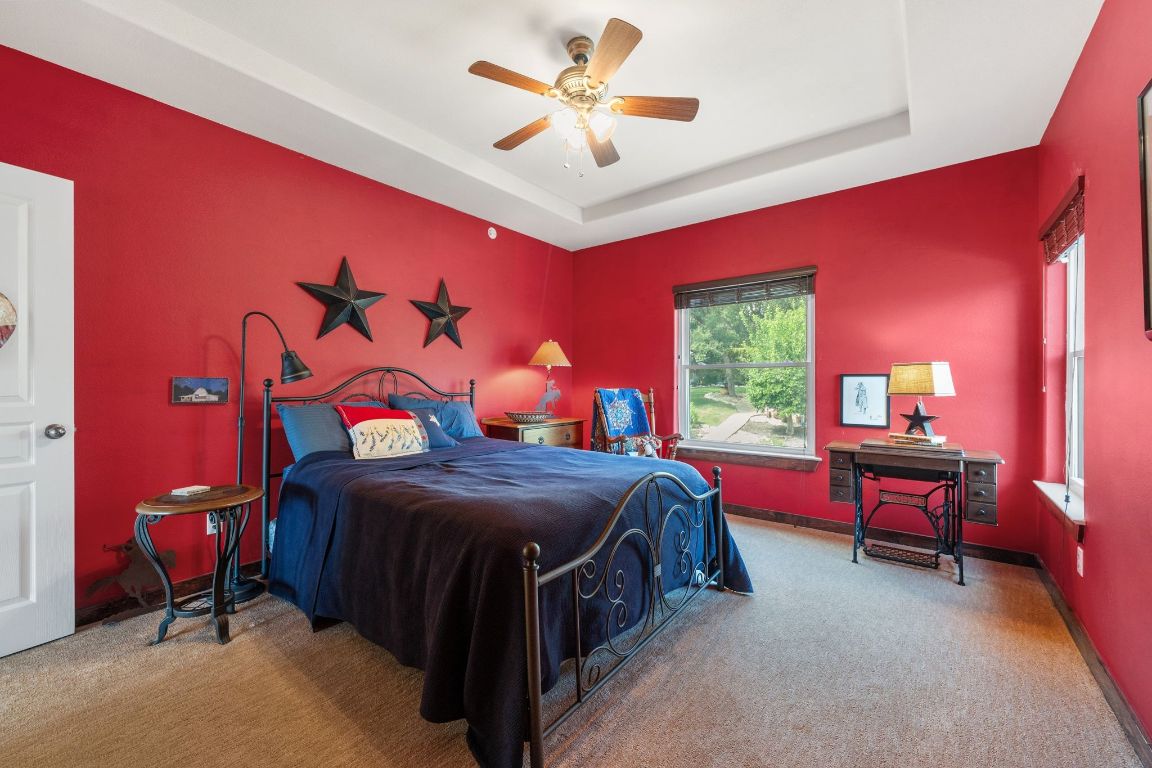 16312 Lake Loop Austin, TX 78734 - Photo 29 of 36 a bedroom with a bed and a chandelier