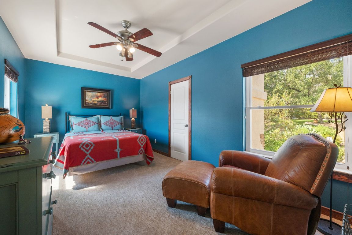 16312 Lake Loop Austin, TX 78734 - Photo 30 of 36 a bedroom with furniture and a large window