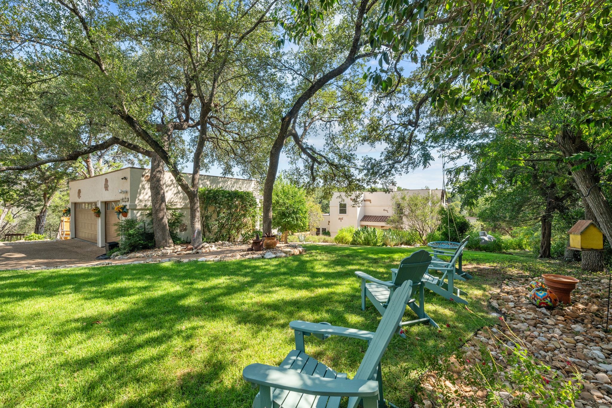 16312 Lake Loop Austin, TX 78734 - Photo 3 of 36 a view of a patio with table and chairs and potted plants and large trees
