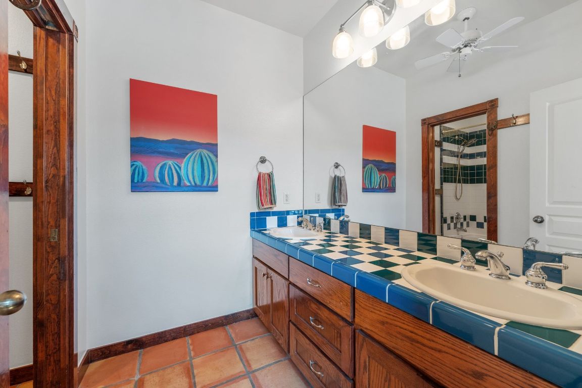 16312 Lake Loop Austin, TX 78734 - Photo 31 of 36 a bathroom with a double vanity sink and a mirror