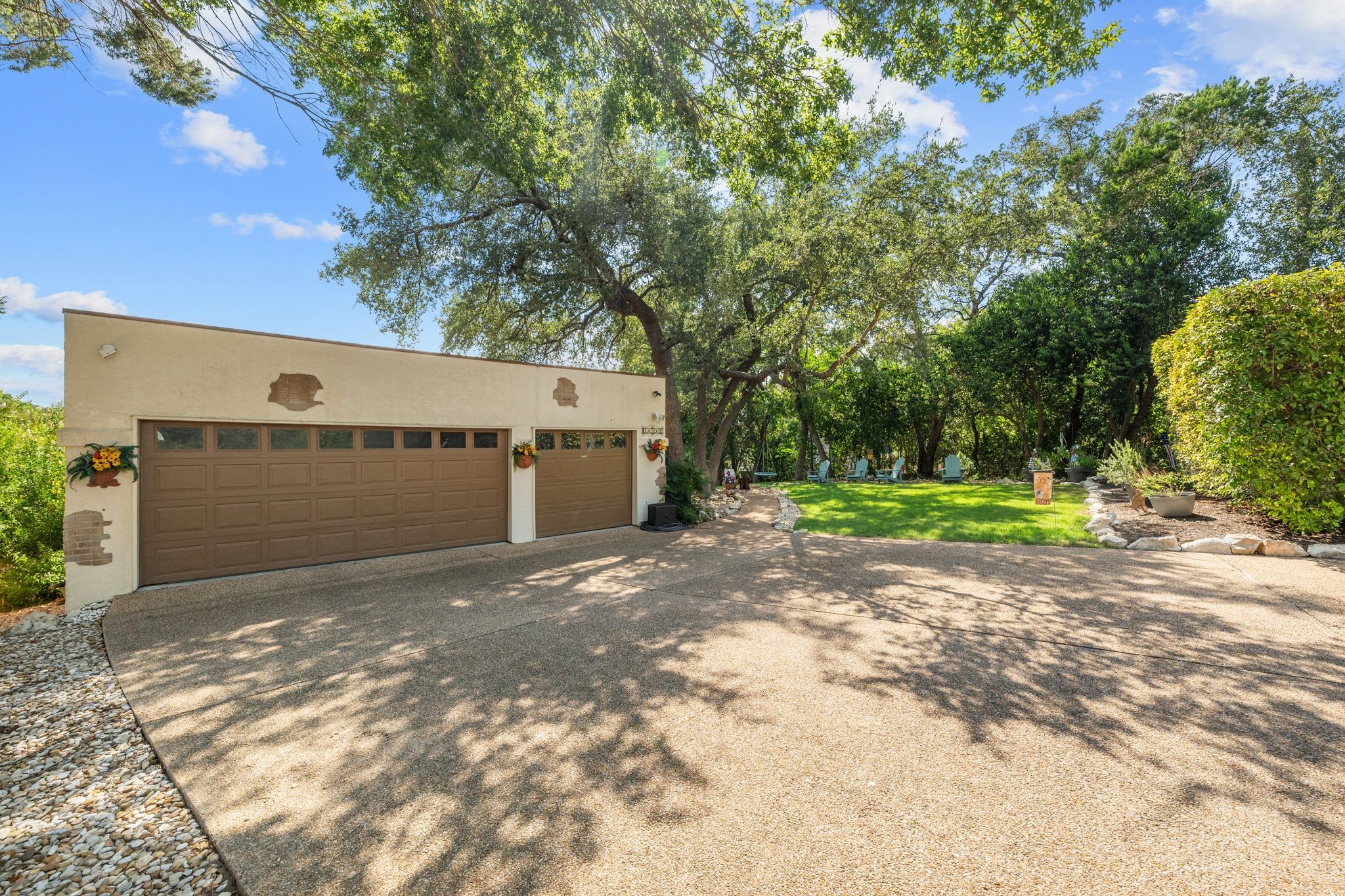 16312 Lake Loop Austin, TX 78734 - Photo 7 of 36 a view of a garage with a tree