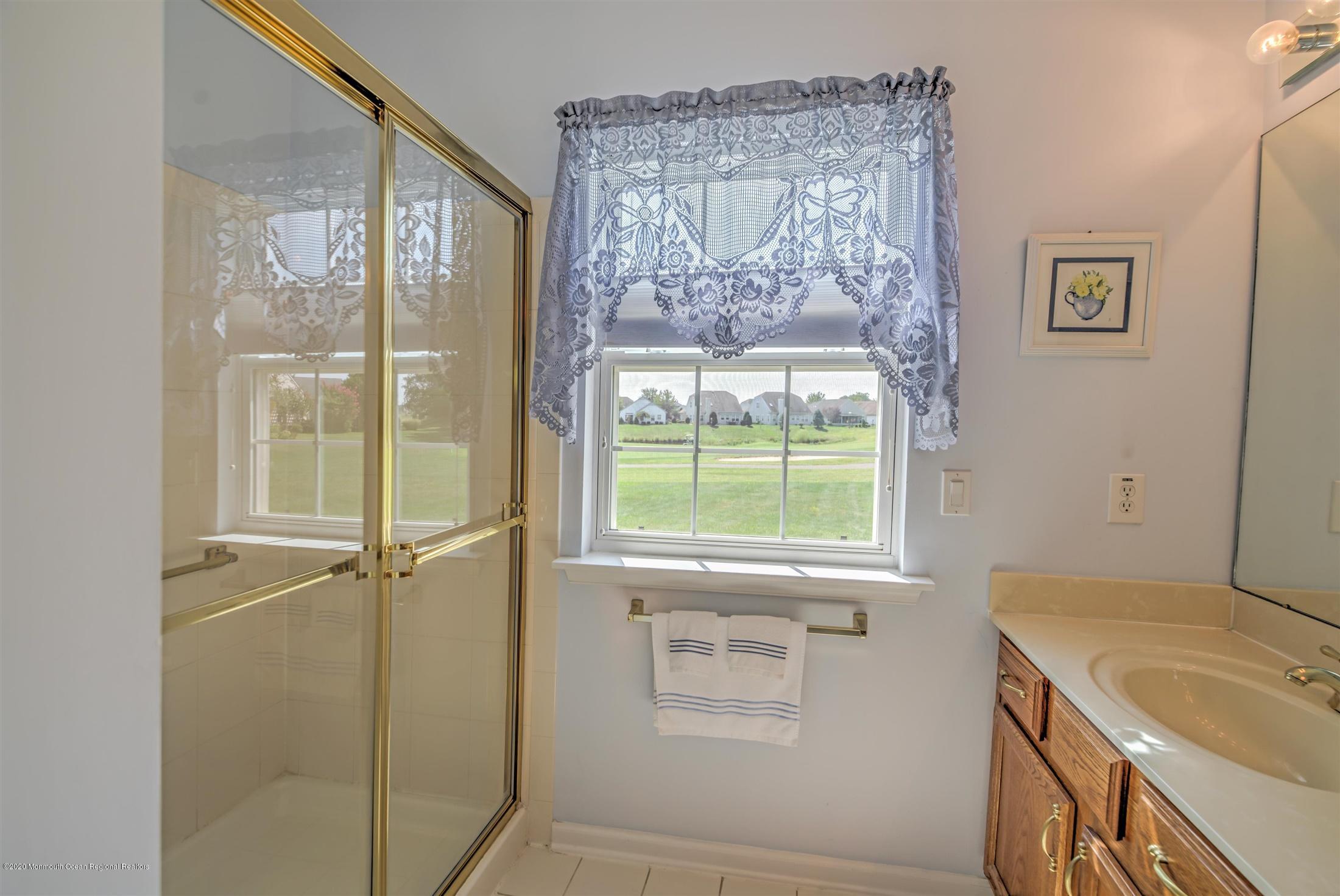 21 Ravenna Road Manchester Township, NJ 08759 - Photo 22 of 44 a bathroom with a granite countertop sink and a shower
