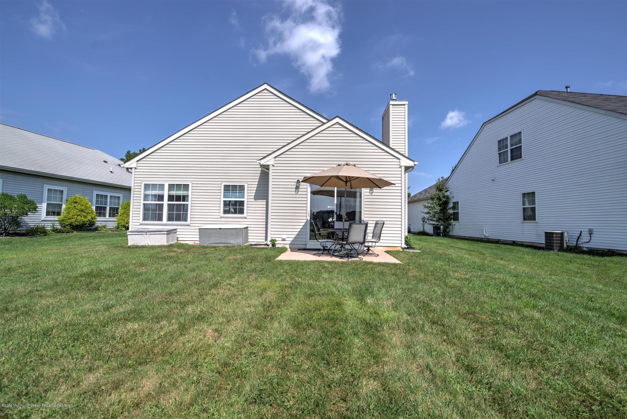 21 Ravenna Road Manchester Township, NJ 08759 - Photo 31 of 44 a view of a house with a yard and sitting area
