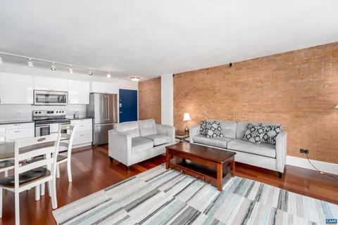 a living room with furniture and a wooden floor