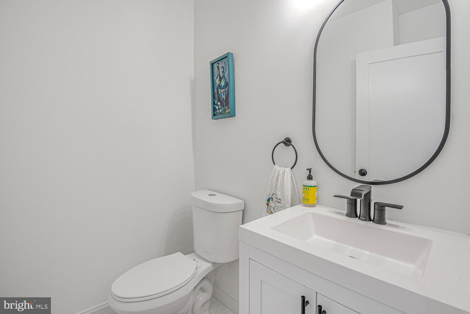 110 Seaton Place Northwest Washington, DC 20001 - Photo 14 of 47 a bathroom with a sink a toilet and a mirror