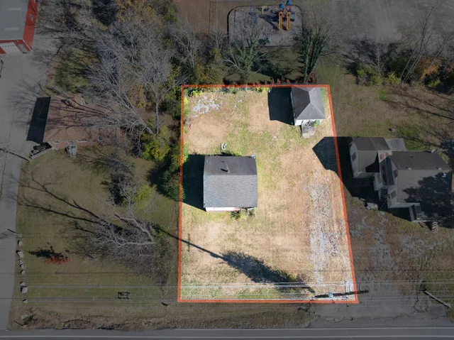 an aerial view of a house with a yard