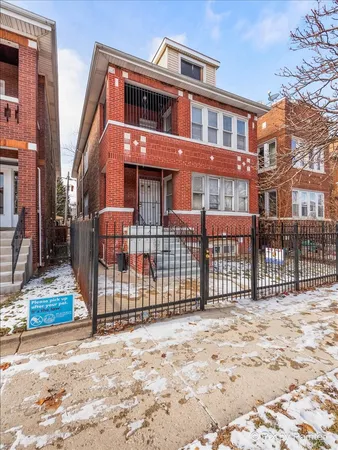 a front view of a house with a fence