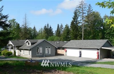 13027 Dubuque Road Snohomish, WA 98290 - Photo 1 of 1 a front view of a house with a garden and yard