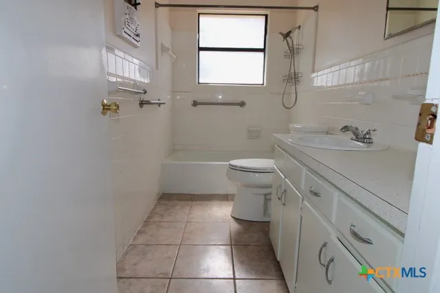 an empty room with a hardwood and ceiling fan