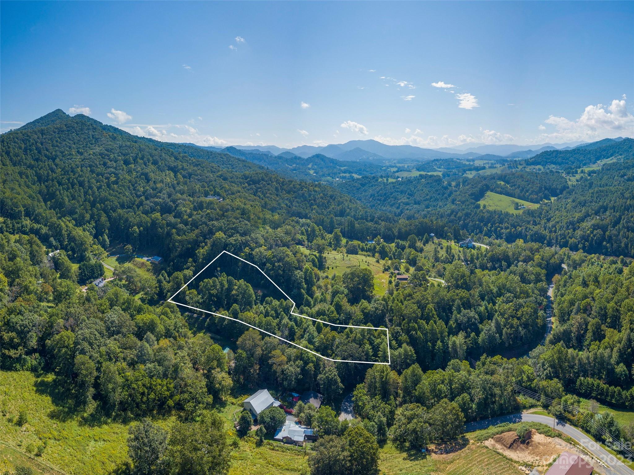 120 Walnut Ridge Drive Clyde, NC 28721 - Photo 12 of 13 a view of a house with a street lush green forest