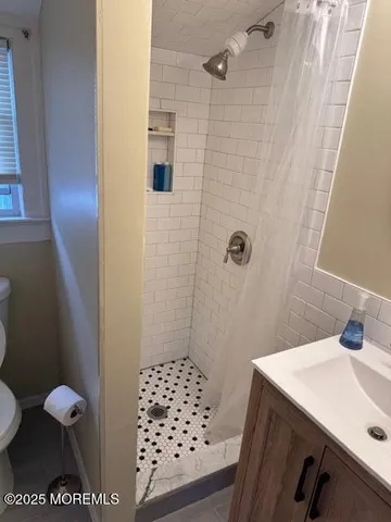 a bathroom with a sink toilet and shower