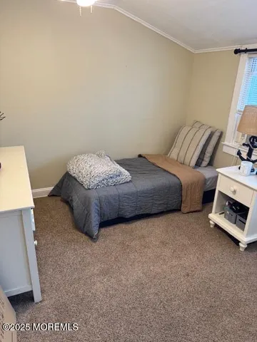 a spacious bedroom with a bed and a couch