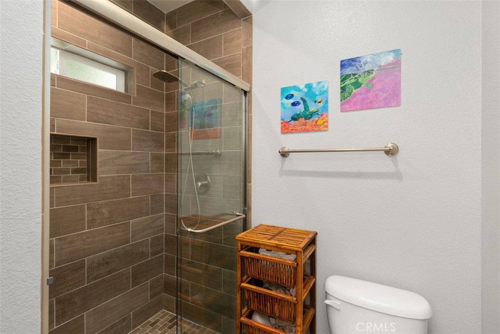 30802 South Coast Highway, Unit K14 Laguna Beach, CA 92651 - Photo 20 of 45 Toilet and shower with door off the bathroom.