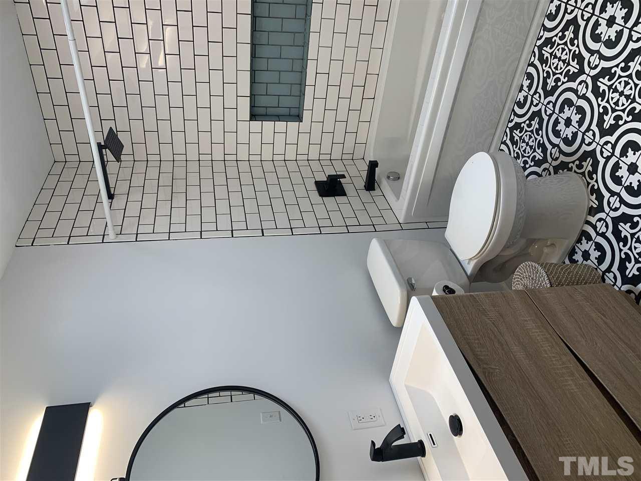 4931 Oak Park Road Raleigh, NC 27612 - Photo 7 of 10 a bathroom with a toilet a sink and bathtub
