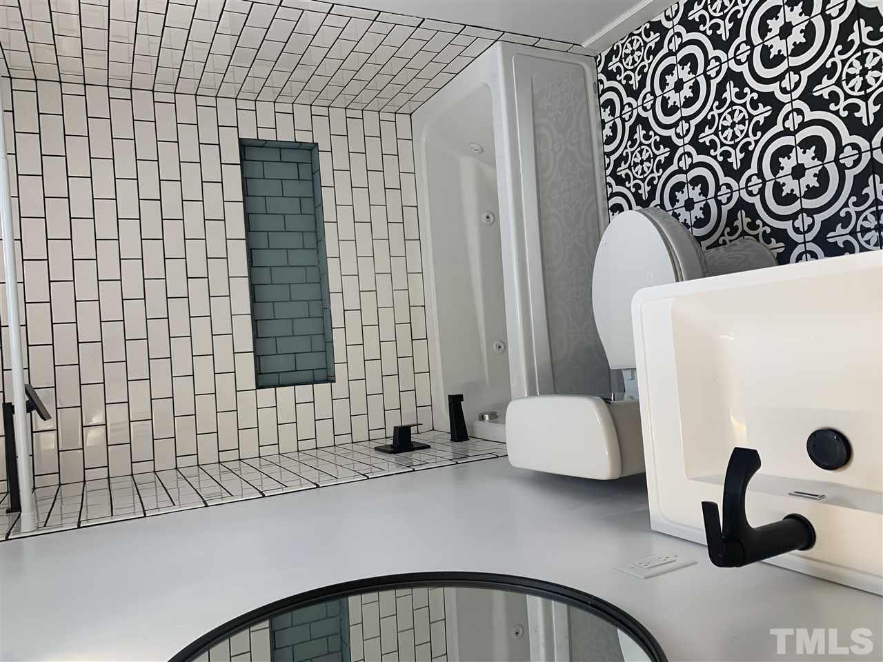 4931 Oak Park Road Raleigh, NC 27612 - Photo 8 of 10 a bathroom with a sink and a bathtub