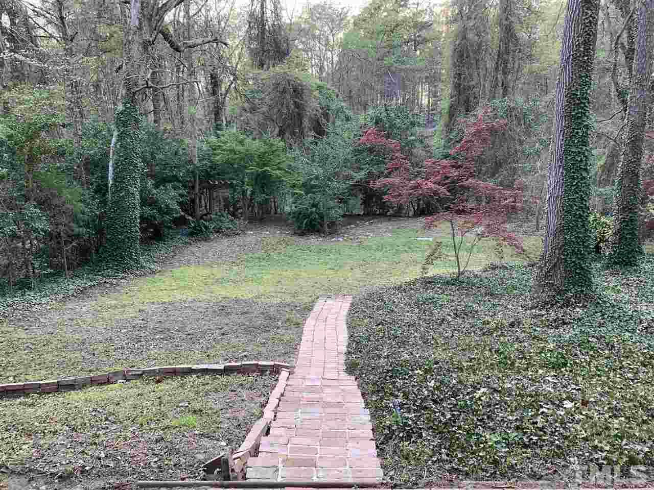 4931 Oak Park Road Raleigh, NC 27612 - Photo 9 of 10 a backyard of a house with lots of green space