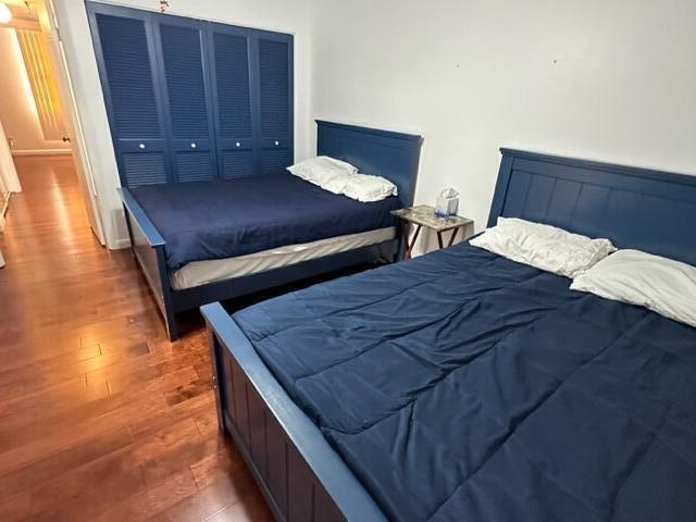 6500 Northwest 2nd Avenue, Unit 512 Boca Raton, FL 33487 - Photo 24 of 41 a bedroom with a bed and wooden floor