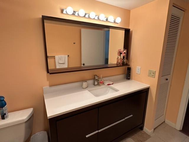 6500 Northwest 2nd Avenue, Unit 512 Boca Raton, FL 33487 - Photo 32 of 41 a bathroom with a sink a toilet and a mirror