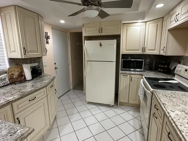 a kitchen with a sink a stove cabinets and counter space